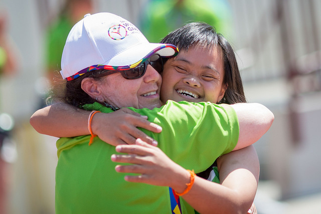 Special Olympian Hugging Volunteer